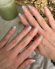 Black and white polka dot-press-on nails on hands
