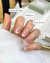 A hand wearing different Loste French press-on nail designs on each hand